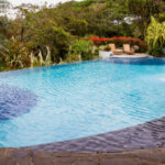 relaxing swimming pool with a waterfall in a tropical rain forest